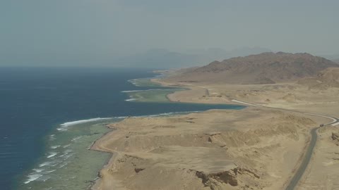 The Neom tourism project road, the eastern coast of the Gulf of Aqaba, areas of tourism development projects, rock formations and structures in Wadi Tayeb Asm in the Tabuk region, mountain ranges in desert areas, drone photography of the terrain and rock carvings in famous historical places in Saudi Arabia.