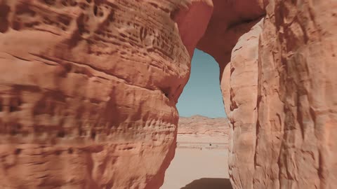 Ancient historical archaeological sites, rock formations and structures in the deserts of the Kingdom of Saudi Arabia, famous natural tourist spots, the soft sands in the desert, aerial drone photography of the elephant rock in Al-Ula Governorate, the view of the blue sky.