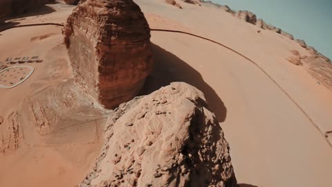 Ancient historical archaeological sites, rock formations and structures in the deserts of the Kingdom of Saudi Arabia, famous natural tourist spots, the soft sands in the desert, aerial drone photography of the elephant rock in Al-Ula Governorate, the view of the blue sky.
