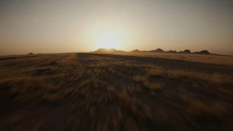 An ancient historical archaeological site, the terrain, peaks, and mountainous elevations in the desert, drone photography of the Aja Mountains in the city of Hail, the mountains and rock formations in the desert areas of the Kingdom of Saudi Arabia at sunset, desert nature and tourism.