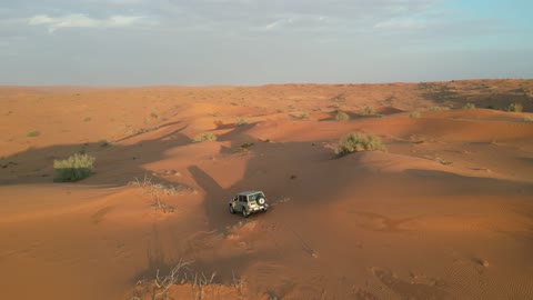 Recreational activities for driving cars in the Saudi desert, safari adventures on hills and sand dunes, a four-wheel drive vehicle moving on golden sands, the terrain and dry environment, a tourist destination for adventure lovers, a trip and camping in the desert areas of the Great Nafud north of the city of Hail.