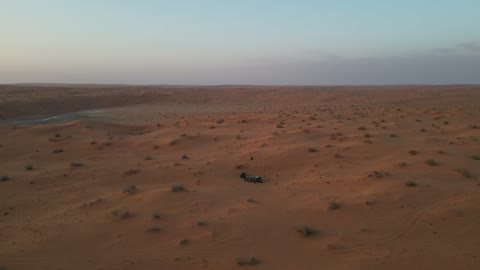 Traditional Arab gatherings in the desert, relaxation and enjoyment in the calm atmosphere, spending a pleasant vacation in the wilderness of the Kingdom of Saudi Arabia, a trip and a wild camping experience in the desert areas of the Great Nafud north of the city of Hail, the view of the soft golden sands, a tourist destination for adventure lovers.