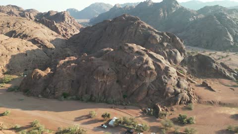 Natural rock formations in Saudi Arabia, drone photography of the desert nature and mountainous environment, rock formations in the mountains, peaks, and highlands, natural tourist spots and ancient historical archaeological sites for wild camping, a tourist destination for adventure lovers, a trip and wild camping in the desert north of Hail city.