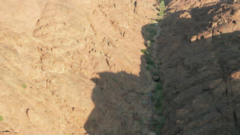 Natural rock formations in Saudi Arabia, drone photography of the desert nature and mountainous environment, rock formations in the mountains, peaks, and highlands, natural tourist spots and ancient historical archaeological sites for wild camping, a tourist destination for adventure lovers, a trip and wild camping in the desert north of Hail city.