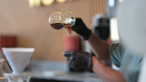 Coffee machine, close-up shot of a young Arab Gulf Saudi man preparing specialty coffee, modern tools and equipment for coffee making, hot beverages to improve mood and feel energized and lively.