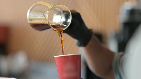Coffee machine, close-up shot of a young Arab Gulf Saudi man preparing specialty coffee, modern tools and equipment for coffee making, hot beverages to improve mood and feel energized and lively.