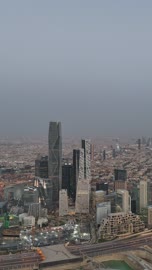 Urban growth and development, the architectural engineering art of modern-style buildings and commercial and residential establishments, car traffic in the capital's streets at sunset, the concept of infrastructure development in the city of Riyadh, towers and skyscrapers in the Kingdom of Saudi Arabia.