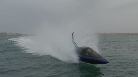 Aerial drone footage of water games and sea shark jet ski, the Dubai Eye Ferris wheel on Blue Waters Island during the day, a view of the Arabian Gulf coastline in the United Arab Emirates, a famous tourist attraction at Jumeirah Beach in Dubai, fun recreational activities and events for families and youth.