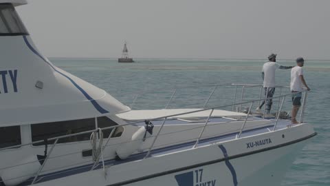 The natural waterfront, Biyadah Island in the city of Jeddah, Saudi Arabia, aerial drone photography of the Saudi flag on the yacht, famous tourist landmarks.