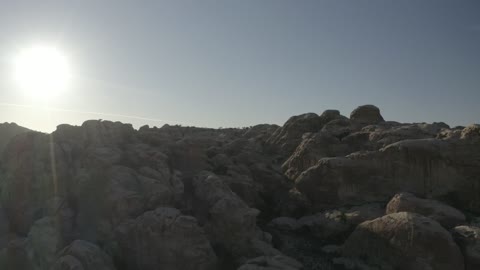 Aerial drone photography of the valleys and mountains in northern Saudi Arabia, rock formations, peaks, highlands, and terrain in mountainous areas.