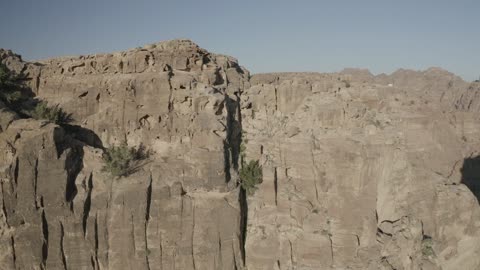 Wadi Rum in the city of Tabuk during the day, the rock formations and structures in the Hasma Desert, the desert environment and the peaks and mountain heights, tourist places in the Kingdom of Saudi Arabia, narrow valleys and natural arches and slopes, nature background.