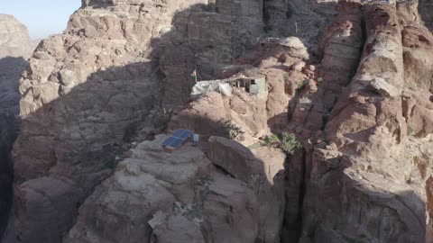 Wadi Rum in the city of Tabuk during the day, the rock formations and structures in the Hasma Desert, the desert environment and the peaks and mountain heights, tourist places in the Kingdom of Saudi Arabia, narrow valleys and natural arches and slopes, nature background.