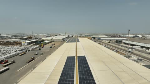 The reflection of sunlight on renewable solar energy stations, the concept of producing environmentally friendly alternative energy in the Kingdom of Saudi Arabia, aerial drone photography of a group of photovoltaic panels.