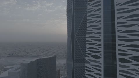 The growth and urban development of skyscrapers in the Kingdom of Saudi Arabia, the architectural engineering art of financial towers and economic facilities in the capital, aerial drone photography of the King Abdullah Financial Center "KAFD" at sunrise, and the famous landmarks of Riyadh.