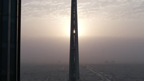 The growth and urban development of skyscrapers in the Kingdom of Saudi Arabia, the architectural engineering art of financial towers and economic facilities in the capital, aerial drone photography of the King Abdullah Financial Center "KAFD" at sunrise, and the famous landmarks of Riyadh.