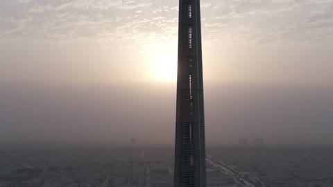 The growth and urban development of skyscrapers in the Kingdom of Saudi Arabia, the architectural engineering art of financial towers and economic facilities in the capital, aerial drone photography of the King Abdullah Financial Center "KAFD" at sunrise, and the famous landmarks of Riyadh.