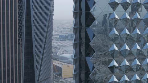 The architectural engineering art of financial towers and economic establishments in the capital, the growth and urban development of skyscrapers in the Kingdom of Saudi Arabia, aerial drone photography of the King Abdullah Financial Center "KAFD" at sunrise, and the famous landmarks of Riyadh.