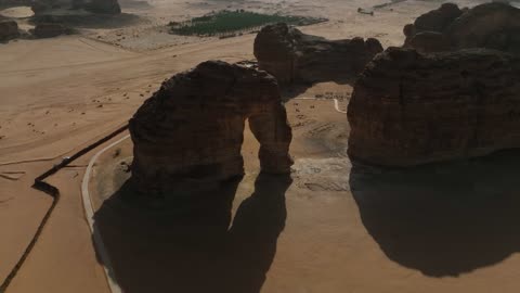 Aerial drone photography of the natural rock formations and structures in the city of Al-Ula, Saudi Arabia, historical archaeological tourist sites, desert nature, rocky mountains in the Al-Ula governorate, tourism in Saudi Arabia.