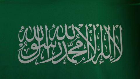 Raising the flag of the founding day with pride, showing loyalty and love for the country, celebrating the anniversary of Saudi National Day, Saudi Flag Day, March 11, the concept of love for the homeland and belonging to it, a portrait of a veiled Saudi Arabian Gulf woman standing and placing the homeland's flag on her shoulders with confidence and pride, beige background.