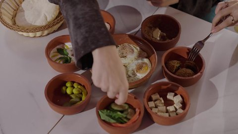 A healthy and quick breakfast meal, a complete breakfast that includes natural and delicious food options, traditional food recipes on the table in the Kingdom, close-up shots of Saudi food dishes in the morning, a plate of fried, well-cooked falafel patties.