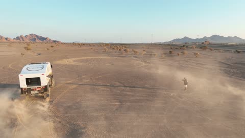 Racing on the soft golden sands, exciting challenges and recreational activities, off-roading with dirt cars in desert areas, famous competitions and events, aerial drone photography of the Dakar Rally in Saudi Arabia, World Rally Championship.