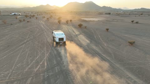 The sport of off-roading with dirt cars in desert areas, racing on soft golden sands, exciting challenges and recreational activities, famous competitions and events, aerial drone photography of the Dakar Rally in Saudi Arabia, World Rally Championship.