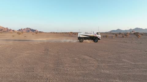 The sport of off-roading with dirt cars in desert areas, racing on soft golden sands, exciting challenges and recreational activities, famous competitions and events, aerial drone photography of the Dakar Rally in Saudi Arabia, World Rally Championship.