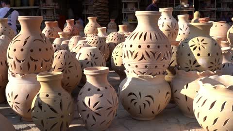 A depiction of utensils in the shape of a model of Nizwa in the Sultanate of Oman, the capital of Islamic culture, tourist attractions in Oman, architectural geometric art.