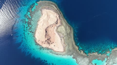 The calmness and beauty of the sea, the waterfront in Tabuk, the beach of Haql Governorate on the shores of the Red Sea in Tabuk, Saudi Arabia, drone photography of Al-Wasl Island, tourist attractions in Tabuk, tourist places, background of marine nature.