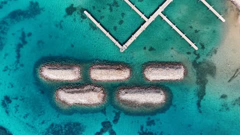 Rock formations and shapes, tourist attractions in Tabuk, a place for ships to dock and stop at the port, the calmness and beauty of the sea, the waterfront in Tabuk, the beach of Haql Governorate on the shores of the Red Sea in Tabuk, Saudi Arabia, drone photography of Haql Marina during its construction, marine nature background.