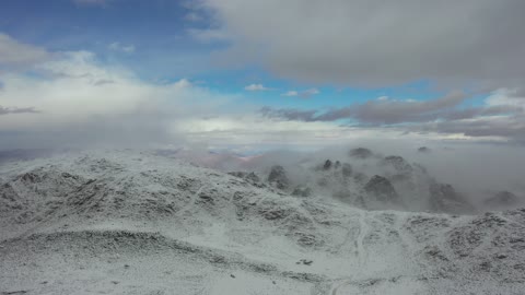 Winter atmosphere, tourist cultural landmarks in the Kingdom of Saudi Arabia, the mountain range in the Trojena area covered in snow, aerial drone photography of rock formations in the village of Jeddah Neom in the west of the Kingdom of Saudi Arabia, landscapes of golden sands, sculpted mountains, and mountain formations in the city of Tabuk.