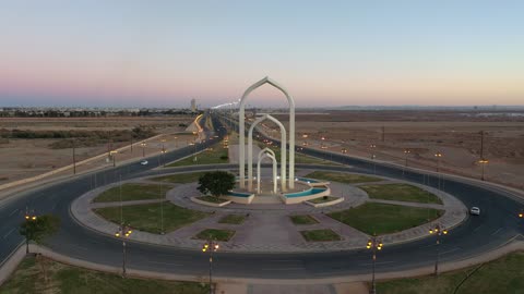 The prominent landmark is the Northern Gate, one of the most distinctive features in the city of Tabuk, Saudi Arabia. It is located on the international road leading to Jordan, and it is the first sight that greets those coming from this road. Its architectural design combines elements of the local environment and cultural heritage.