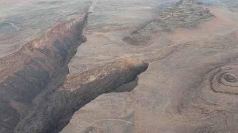 Steep sides and a deep, narrow valley, drone photography of Shaq Shaqri in Tabuk, Saudi Arabia, mountain formations, Shaq Shaqri, mountains and highlands, desert terrain, mountainous nature, mountain fault, natural landmarks of Tabuk, tourism in Saudi Arabia.
