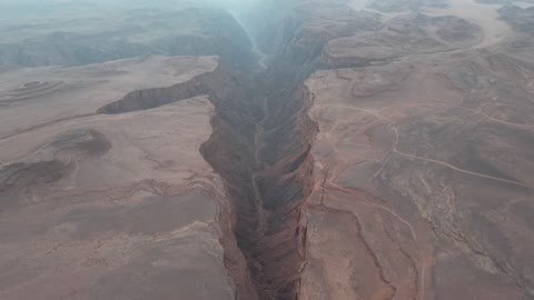 The walls are rugged and steep, drone photography of Shaq Shaqri in Tabuk, Saudi Arabia, mountain formations, Shaq Shaqri, mountains and highlands, desert terrain, mountainous nature, geological fault, natural landmarks of Tabuk, tourism in Saudi Arabia.