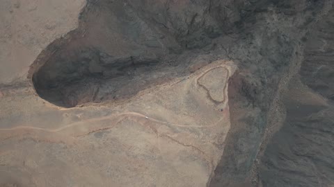 Low rainfall or surface water, drone photography of Shak Shuqri in Tabuk, Saudi Arabia, mountain formations, Shak Shuqri, mountains and highlands, desert terrain, mountainous nature, mountain fault, natural landmarks of Tabuk, tourism in Saudi Arabia.