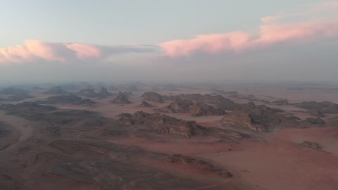 The sunlight scatters at sunrise in the sky, a protected desert wilderness area, drone photography of the Shaqri Mountains in Tabuk, Saudi Arabia, mountain formations, Shaqri crack, mountains and highlands, desert terrain, mountainous nature, mountain fault, natural landmarks of Tabuk.