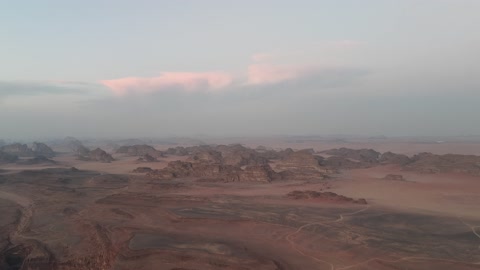 The sunlight scatters at sunrise in the sky, a protected desert wilderness area, drone photography of the Shaqri Mountains in Tabuk, Saudi Arabia, mountain formations, Shaqri crack, mountains and highlands, desert terrain, mountainous nature, mountain fault, natural landmarks of Tabuk.