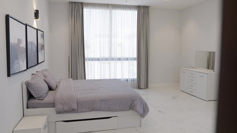 A bedroom with luxurious home furniture, the interior design of a relaxation room in a modern style in one of the luxury chalets, equipping the suite with all high-end furnishings, elegant interior decor for villas and residential apartments in the Kingdom of Saudi Arabia.