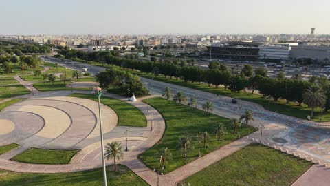 Strolling and enjoying public parks, drone photography of Prince Fahd bin Sultan Park in Tabuk Province, attention to afforestation and planting green plants in parks and recreational areas, a famous tourist spot and landmark, a distinctive natural view in the Kingdom of Saudi Arabia.