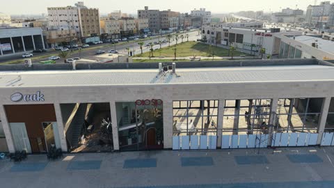 مركز ترفيهي وتجاري، الفن الهندسي المعماري على الطراز الحديث والمتطور في المملكة العربية السعودية، المطاعم والمقاهي والمراكز التجارية المميزة، تصوير درون لمجمع ماي ووك في شارع عمرو بن العاص في حي المصيف بمدينة تبوك في وقت النهار، مكان للتسوق وقضاء وقت ممتع