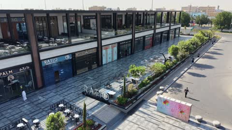 Practicing hobbies and entertaining games, a place for play and fun and spending enjoyable time, modern and advanced architectural engineering art in the Kingdom of Saudi Arabia, distinctive cafes and play areas, drone photography of billiards and cafes in Tabuk on Prince Fahd bin Sultan Road in the city of Tabuk during the daytime.