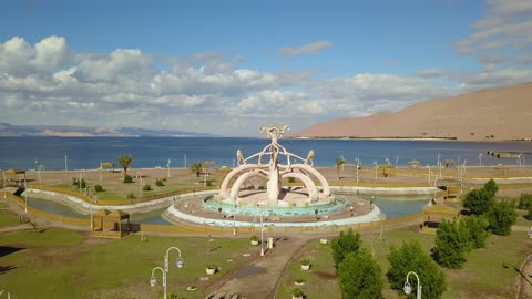 Famous landmarks and places for recreation and entertainment in Saudi Arabia, Prince Fahd bin Sultan Park, events and recreational activities in family parks and gardens, drone photography of Prince Fahd bin Sultan Park in Tabuk, interest in planting trees and green plants.