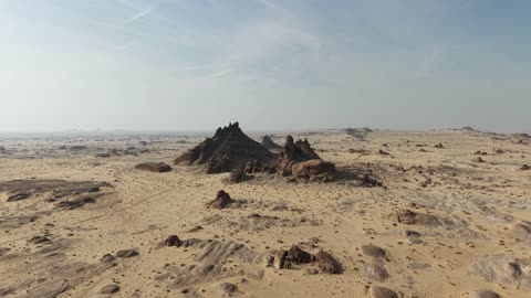 A depiction of mountains with rock formations in the Tayma region of the Kingdom of Saudi Arabia, natural landscapes of golden sands, and cultural tourist landmarks in the Kingdom of Saudi Arabia.