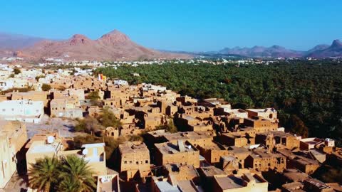 Aerial drone photography of the old town of Al Hamra in Oman, the mud houses and homes, Jebel Shams, historical heritage landmarks, natural background.