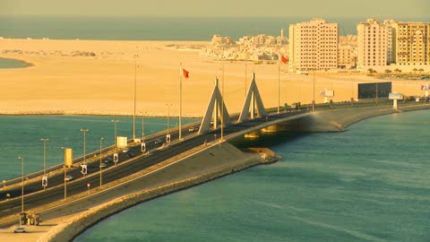 Architectural engineering art in the modern style, depicting the King Hamad Bridge connecting Saudi Arabia and Bahrain, Muharraq and the buildings of Al-Basitain, the water nature and distinctive landscapes, car traffic on the bridges, famous places and landmarks.