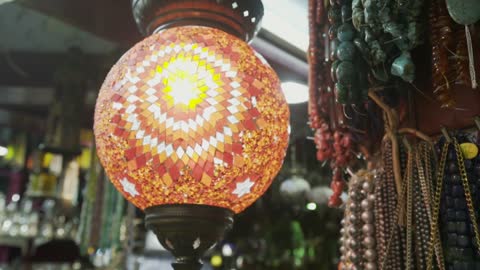 The Muttrah Souq from the inside in the Sultanate of Oman, the art of engineering and ancient architectural design, famous tourist landmarks, brightly colored illuminated lamps, popular markets, heritage archaeological sites, colorful decorations and engravings.