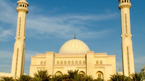 The architectural engineering art from the outside, the Great Al-Fateh Mosque in Manama, Kingdom of Bahrain, Islamic religious landmarks, car traffic in the streets.