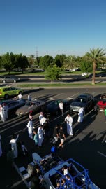 The movement of internal trade in the Kingdom of Saudi Arabia, attracting customers and consumers through a distinctive car display method, a market for buying and selling used cars, drone photography of rows of vehicles from various global brands in a car exhibition area in the Tabuk region.