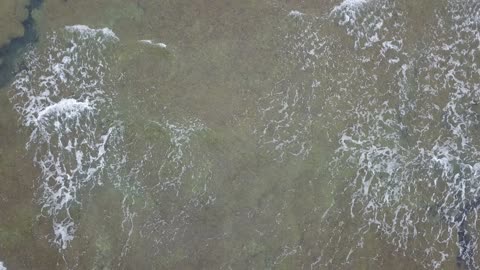 The sea of the historical Al-Wajh Governorate on the Red Sea coast in the Kingdom of Saudi Arabia, drone footage of the Red Sea waves on the sandy beaches, water wealth and natural environment, natural tourist attractions.