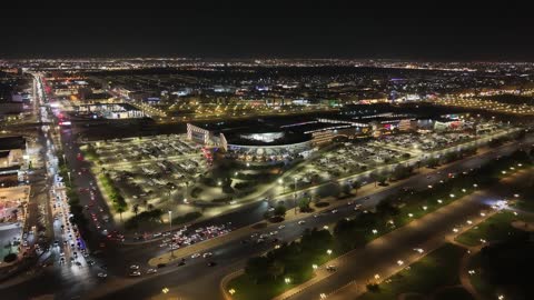 A prominent family shopping and entertainment destination, drone footage of Park Mall on King Faisal Road in the Prince Murooj neighborhood in the city of Tabuk, modern architectural design, places to enjoy quality time with family in the Kingdom of Saudi Arabia.